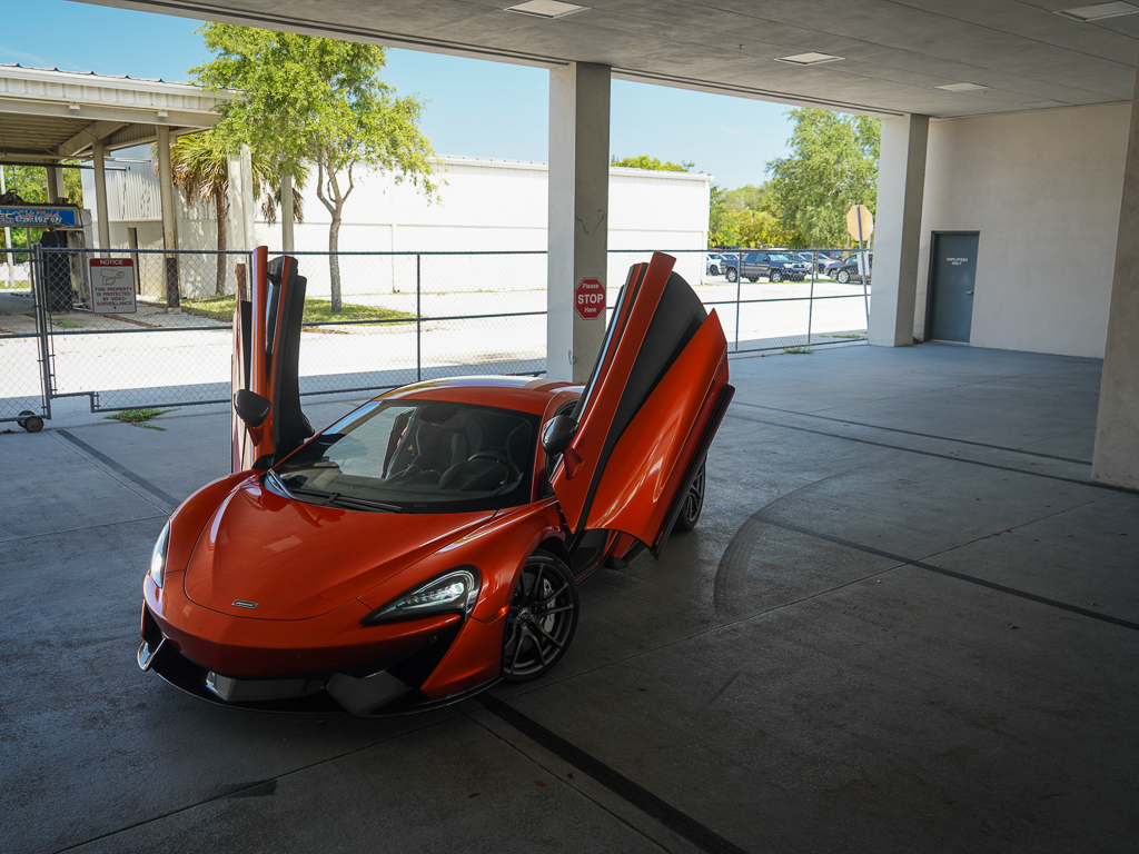 Red Mclaren 12c with doors open