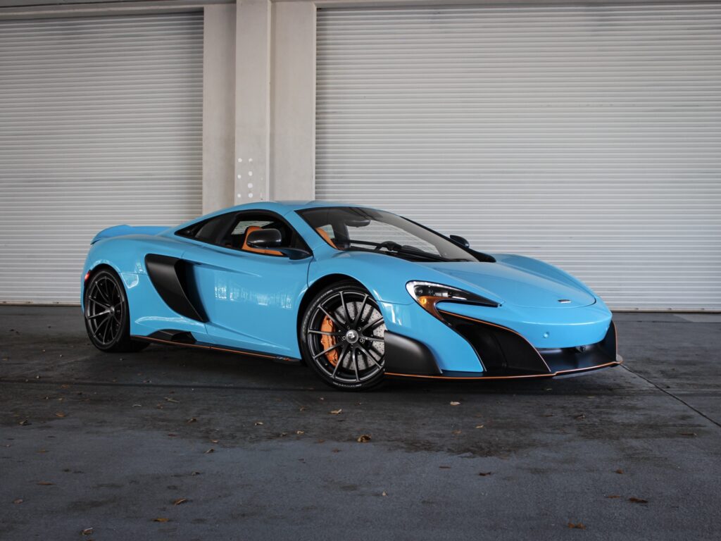 A sky blue McLaren 650s with orange trim